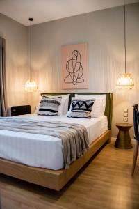 a bedroom with a large bed with two pillows at Ambient Living in Preveza