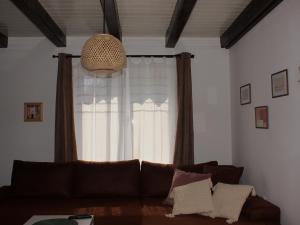 a living room with a couch in front of a window at Buzzing Retreat in Velika Remeta