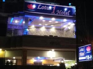a building with a sign for a hotel at night at Lotus One Hotel in Lahore