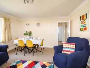 a dining room with a table and chairs at Homely 4-Bed House close to stunning beach in Pwllheli