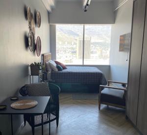 a bedroom with a bed and a large window at Welcome to Cape Town! in Cape Town