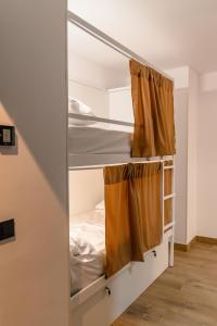 a room with bunk beds in a stair room at VAD HOSTEL ALICANTE in Alicante