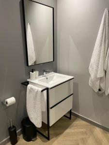 a bathroom with a white sink and a mirror at Welcome to Cape Town! in Cape Town