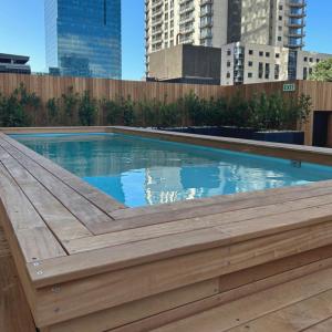 a swimming pool with a wooden deck on a building at Welcome to Cape Town! in Cape Town