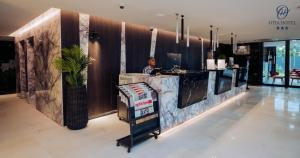 a man sitting at a counter in a restaurant at OTIA HOTEL in Maputo