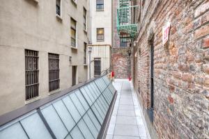 an alleyway between two buildings with a brick wall at SoHo 1br w outdoor space in-unit wd NYC-1142 in New York
