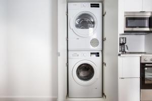 a washer and dryer in a kitchen next to a microwave at SoHo 1br w outdoor space in-unit wd NYC-1142 in New York