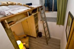 a small room with a bunk bed and a ladder at Beach House San Sebastian in San Sebastián +2 photos