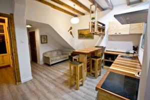 a kitchen with a table and a couch in a room at Beach House San Sebastian in San Sebastián