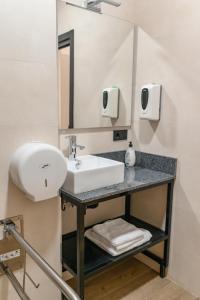 a bathroom with a sink and a mirror at VAD HOSTEL ALICANTE in Alicante