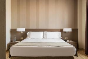 מיטה או מיטות בחדר ב-Hotel SB Ciutat Tarragona