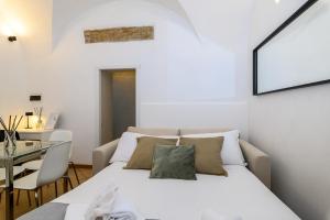 a bedroom with a white bed and a table at Cozy & Central with Private Entrance - NDP Rent in Rome