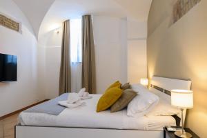 a bedroom with a bed with yellow pillows and a window at Cozy & Central with Private Entrance - NDP Rent in Rome