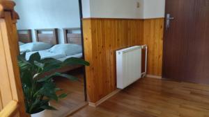 a room with two beds and a plant in it at Dovolenkovy dom in Ružomberok