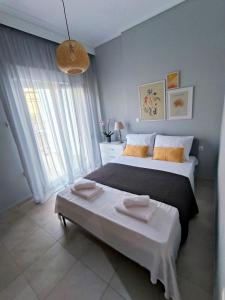 a bedroom with a large bed and a large window at Zoe Apartment in Kavála
