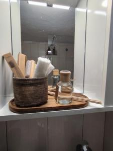 a wooden cutting board with a bottle of perfume on a counter at Zoe Apartment in Kavála