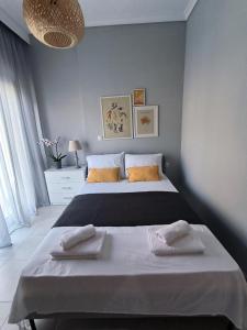 a bedroom with a large bed with two pillows at Zoe Apartment in Kavála