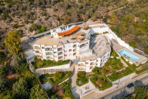 an aerial view of a mansion with a swimming pool at Lydia's Luxury Apartment in Loutraki