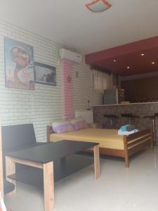 a room with two beds and a table at argiri appartments in Olympiada