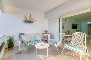 a living room with chairs and a table at Lydia's Luxury Apartment in Loutraki