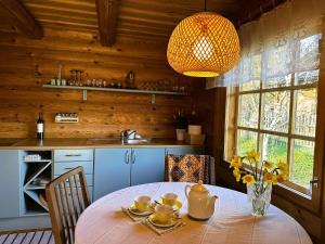 a kitchen with a table with cups and a lamp at Kõrre Puhketare in Vääna-Jõesuu