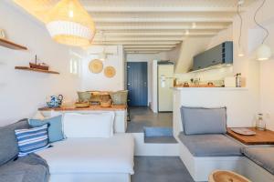 a living room with a couch and a kitchen at Mykonos Perla Town House in Mikonos