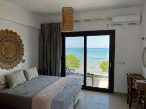 a bedroom with a bed and a view of the ocean at Beach House I&II in Alykes