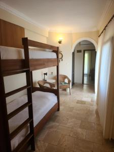 a room with two bunk beds and a hallway at Hotel Villa Monte in Cıralı