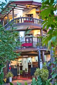 a large building with a balcony on top of it at Sri Lancashire Guest House in Bentota