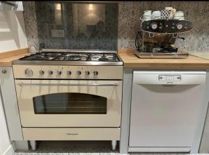 a kitchen with a stove and a white oven at Guest house Festinalente in Montegrotto Terme