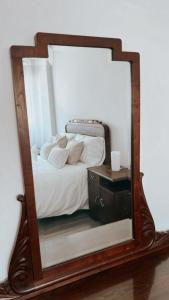 a mirror with a bed in a room at Piso BOIRO PLAYA Robustiano in Boiro