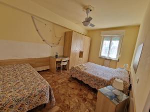 A bed or beds in a room at Ligure Residence