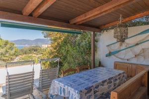 a porch with a table and a view of the ocean at Capo Bianco Studio by HelloElba in Portoferraio