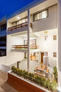 an apartment building with a balcony and a patio at City white beach house2 Hua Hin in Hua Hin