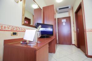 a room with a desk with a flat screen tv at Felix Hotel in Montecchio Maggiore