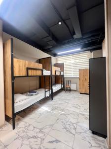 a room with bunk beds and a large window at Mega Hostel in Almaty +15 photos