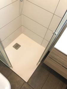 a small shower room with a glass door at Beach House San Sebastian in San Sebastián