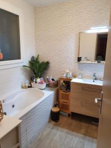 a bathroom with a large tub and two sinks at Villa Agde très calme in Agde +15 photos