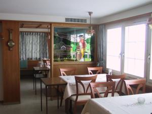a dining room with tables and chairs and a window at Gasthaus Bären Schlatt in Appenzell