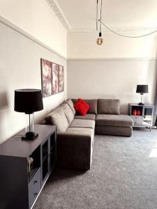 a living room with a couch and a table at The Retreat - Luxury apartment, 2 mins from beach. in Bournemouth