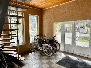 a group of bikes parked in a room next to a door at Villa Gāles Hotel in Saulkrasti