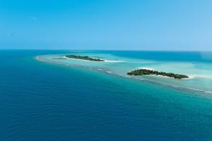 an aerial view of two islands in the ocean at Six Senses Kanuhura in Lhaviyani Atoll