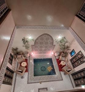 an overhead view of a swimming pool in a building at Riad Bab Nour in Marrakech