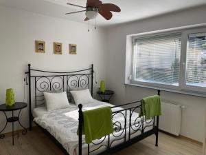 a bedroom with a bed and a ceiling fan at Apartments Rose in winter in Bled