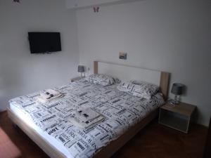 a bedroom with a bed with a tv on the wall at Apartments Villa Anton in Poreč