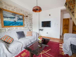 a living room with a couch and a table at Apartments Stone House in Tivat