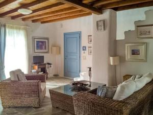 a living room with a couch and chairs and a table at MY CYCLADIC HOME , 5 min walk to Ornos beach in Ornos