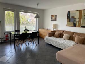 a living room with a couch and a table at Apartments Rose in winter in Bled