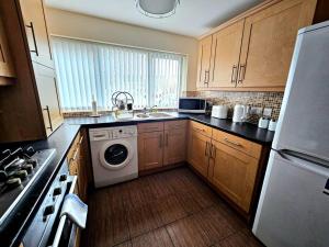 a kitchen with a sink and a washing machine at Baltic Townhouse, 4 Bed, Parking - Pass the Keys in Liverpool