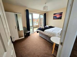 a hotel room with a bed and a window at Baltic Townhouse, 4 Bed, Parking - Pass the Keys in Liverpool
